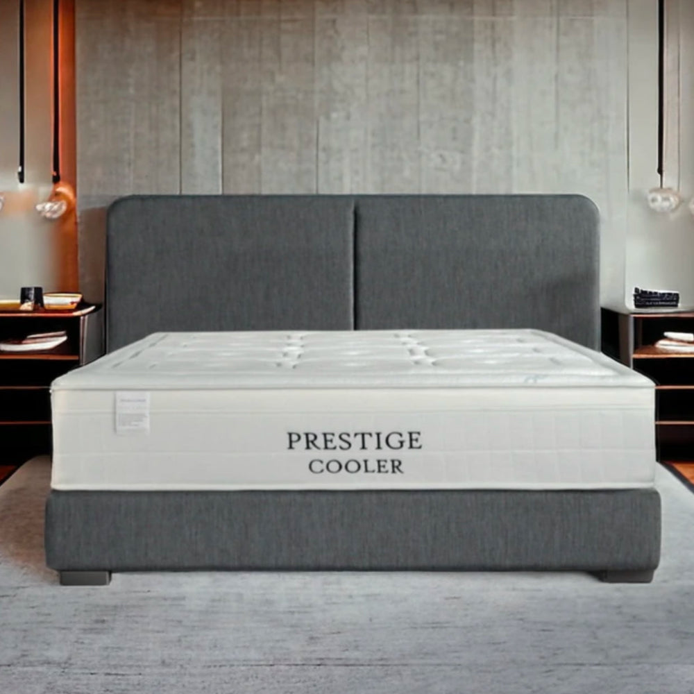 Modern bedroom with a "Prestige Cooler" mattress on a gray bed.